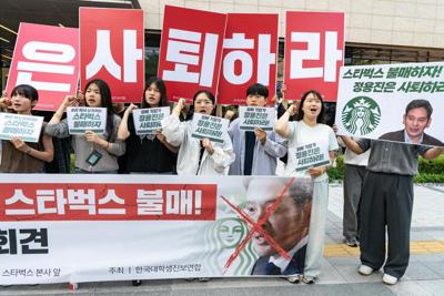 Protesters appear in front of Starbucks Korea headquarters in Seoul after the company launched its 'Tank Day' campaign, which sparked widespread backlash.