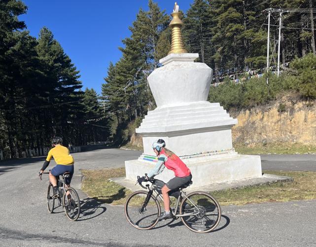 Brits Mark and Julia Swindall ride around a stupa, or Buddhist shrine.
