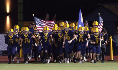The Hood River Valley football team runs out before a game earlier this year  Zach Thummel photo