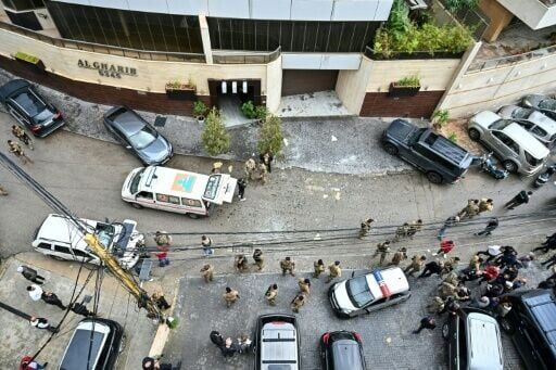 Lebanese soldiers and emergency personnel at the site of an Israeli strike that hit an apartment in Hazmieh, on the eastern outskirts of Beirut