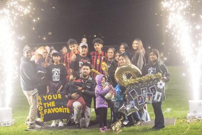 Angel Morales (19) poses with his family for senior night.  Martin Gibson photo