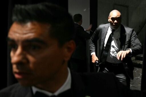 Agents draw their guns after loud bangs were heard during the media gala at the Washington Hilton where President Donald Trump was guest of honor