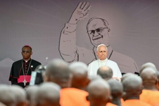 Pope Leo stands in front of inmates gathered for his visit to Bata Prison