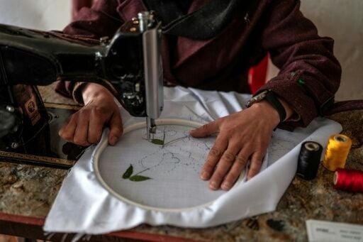 Rahima Alavi embroiders a scarf at her boutique in Bamiyan