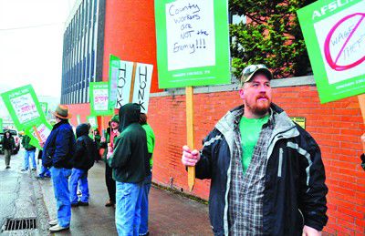 County employees protest contract forcing them to pay retroactive health care costs