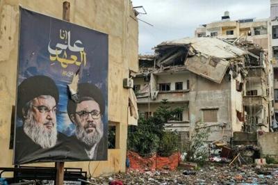 Banners bearing portraits the slain leaders of Lebanon's Hezbollah movement now look down on ruins left by the latest Israeli strikes
