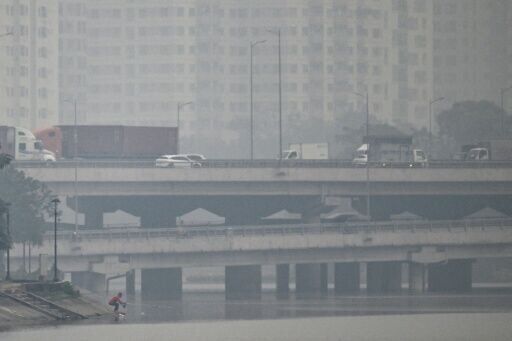Vehicles drive on a highway during heavy air pollution in Hanoi on December 11, 2025
