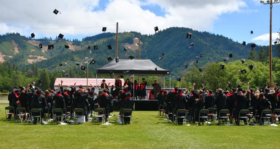 Graduates at Columbia High School in White Salmon toss their caps after the ceremony on Saturday, June 6.