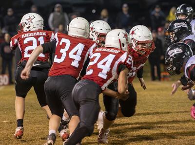 Gavin Anderson (21) takes the snap as his linemen pull against Perrydale on Nov. 14  Zach Thummel Photo