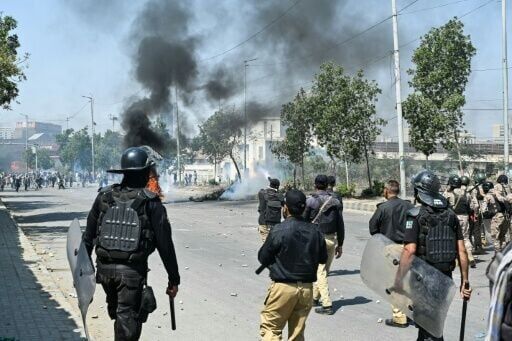 Police fire tear gas at Shiite Muslims as they stage protests in solidarity with Iran outside the US consulate in Karachi on March 1, 2026.