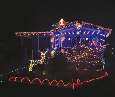 A brightly decorated home in downtown Mosier spread Christmas cheer with their holiday lights. Photo by Laurel Brown.