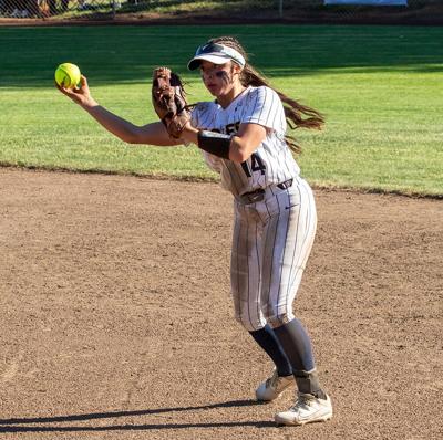Kenadie Lucas (14) launches the ball to first base last year.
