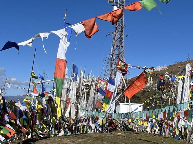 Travelogue author Paul Crowley at a prayer wheel. Photo by Amy Puls