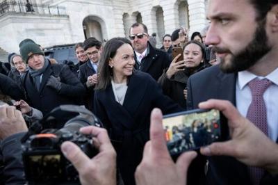 Venezuelan opposition leader Maria Corina Machado (C) said she presented her Nobel Peace Prize medal to US President Donald Trump during a meeting at the White House