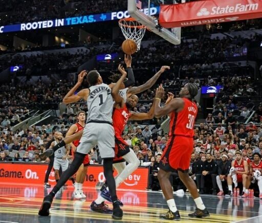 Victor Wembanyama of the San Antonio Spurs fights for a rebound with Kevin Durant in the Spurs' NBA victory over the Houston Rockets