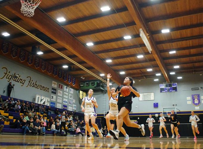 The Dalles', Anuhea Peters (#21) out hustles the Astoria defense during a fast break and scores a lay-up in the fourth quarter on Saturday afternoon at Astoria High School.