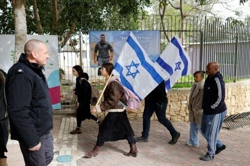 Mourners carrying Israeli flags gathered for the funeral ceremony in Meitar