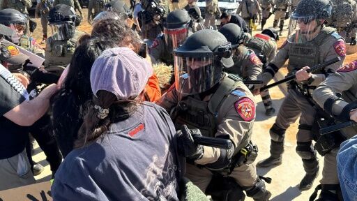 Protestors and law enforcement clash during a demonstration outside the South Texas Family Residential Center in Dilley, Texas