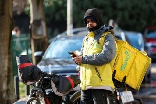 A foreign delivery rider checks on his orders in central Zagreb