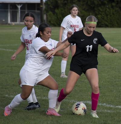 Ariana Gonzalez (11) dribbles the ball past a defender earlier this year.  Zach Thummel photo