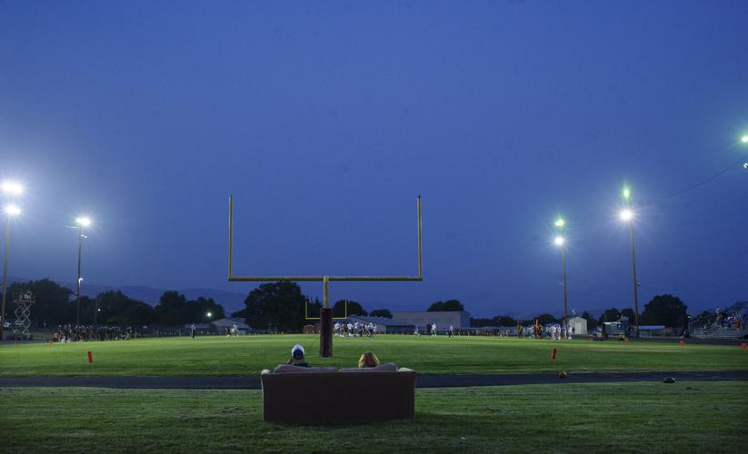 Fans watch The Dalles High School's homecoming game get underway from an endzone sofa Sept. 20. 2022.