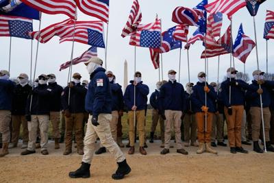 Members of Patriot Front hold flags on the National Mall in Washington on Jan. 23, 2026.