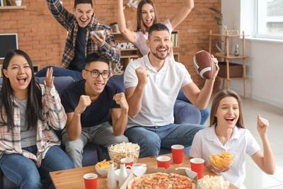Group of fans watching football on TV