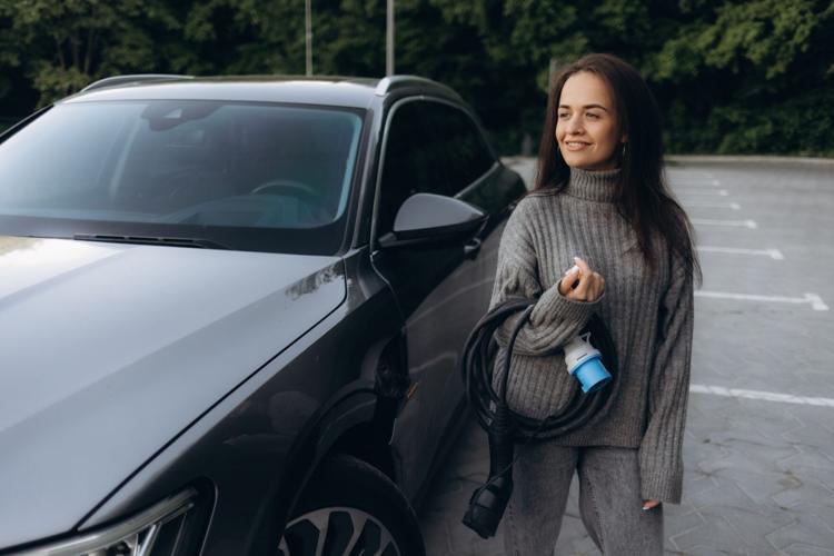 Unrecognizable,Woman,Holding,The,Portable,Ev,Emergency,Charging,Adapter,And