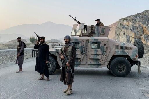 Taliban security personnel stand guard near the Torkham border crossing between Afghanistan and Pakistan in the Nangarhar province