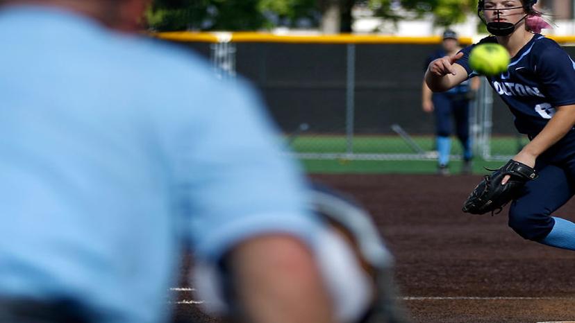 Sporting her rally cap, Paige Bedsworth watches a teammate at the