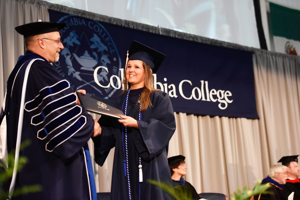 Pascale White receives her bachelor's degree in general studies from Columbia College president