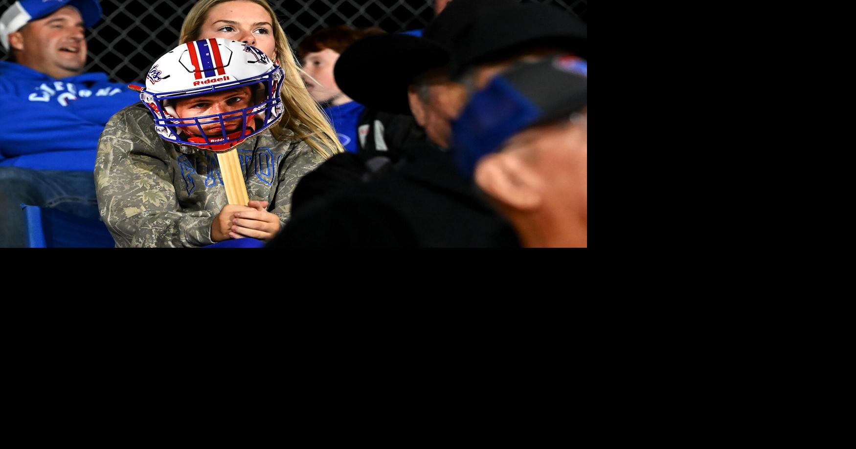Lexy Messerli holds a cardboard cutout of California High School running back, Evan Turner’s head