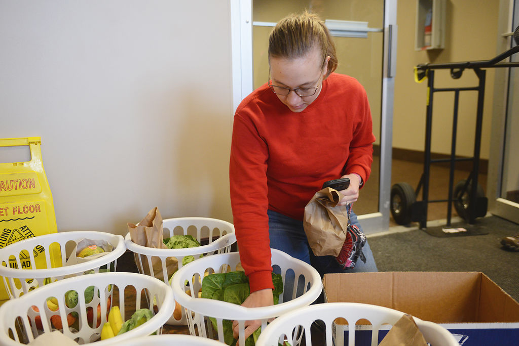 Julia Jackson, looks through baskets of produce to purchase