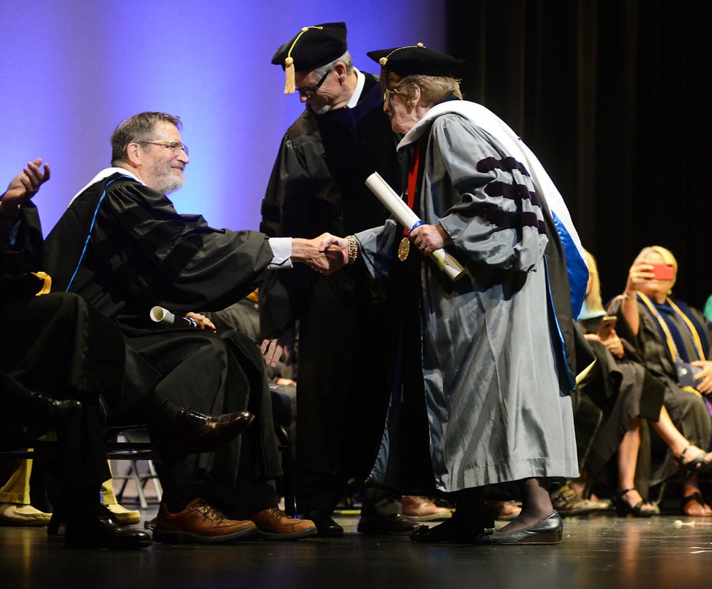 MU Professor Emeritus of biology Dr. George Smith shakes hands with former U.S. Secretary of State Dr. Madeleine Albright