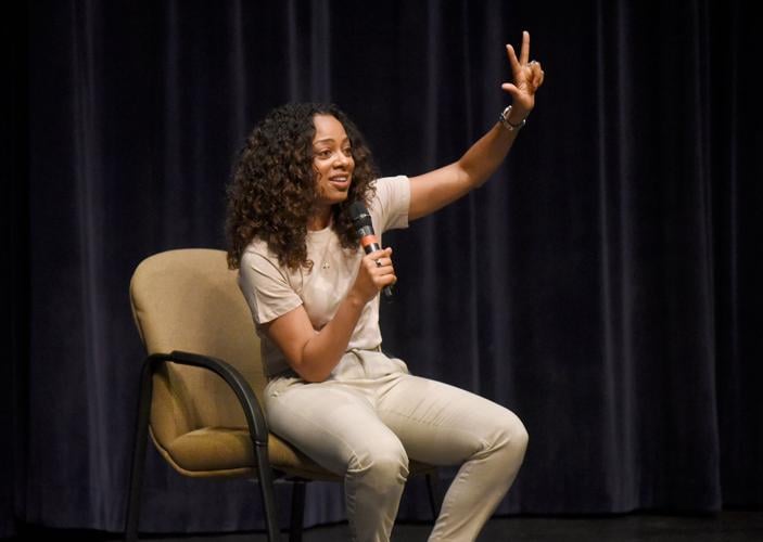 Nischelle Turner holds up three fingers