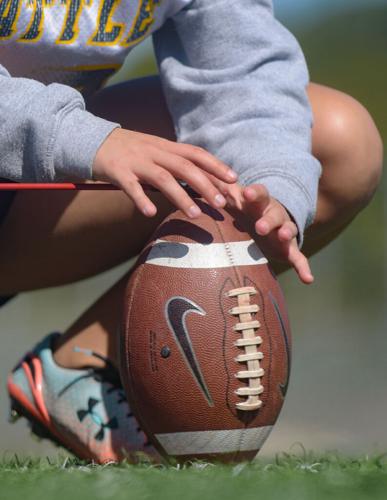 Sam Schupp sets up the ball for a kick