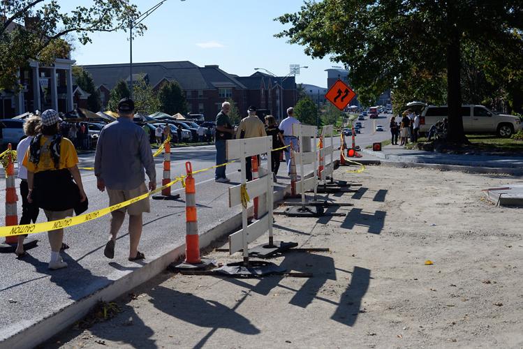 Pedestrians pass construction on Providence Road