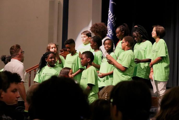 The fifth grade class preforms a song for the audience