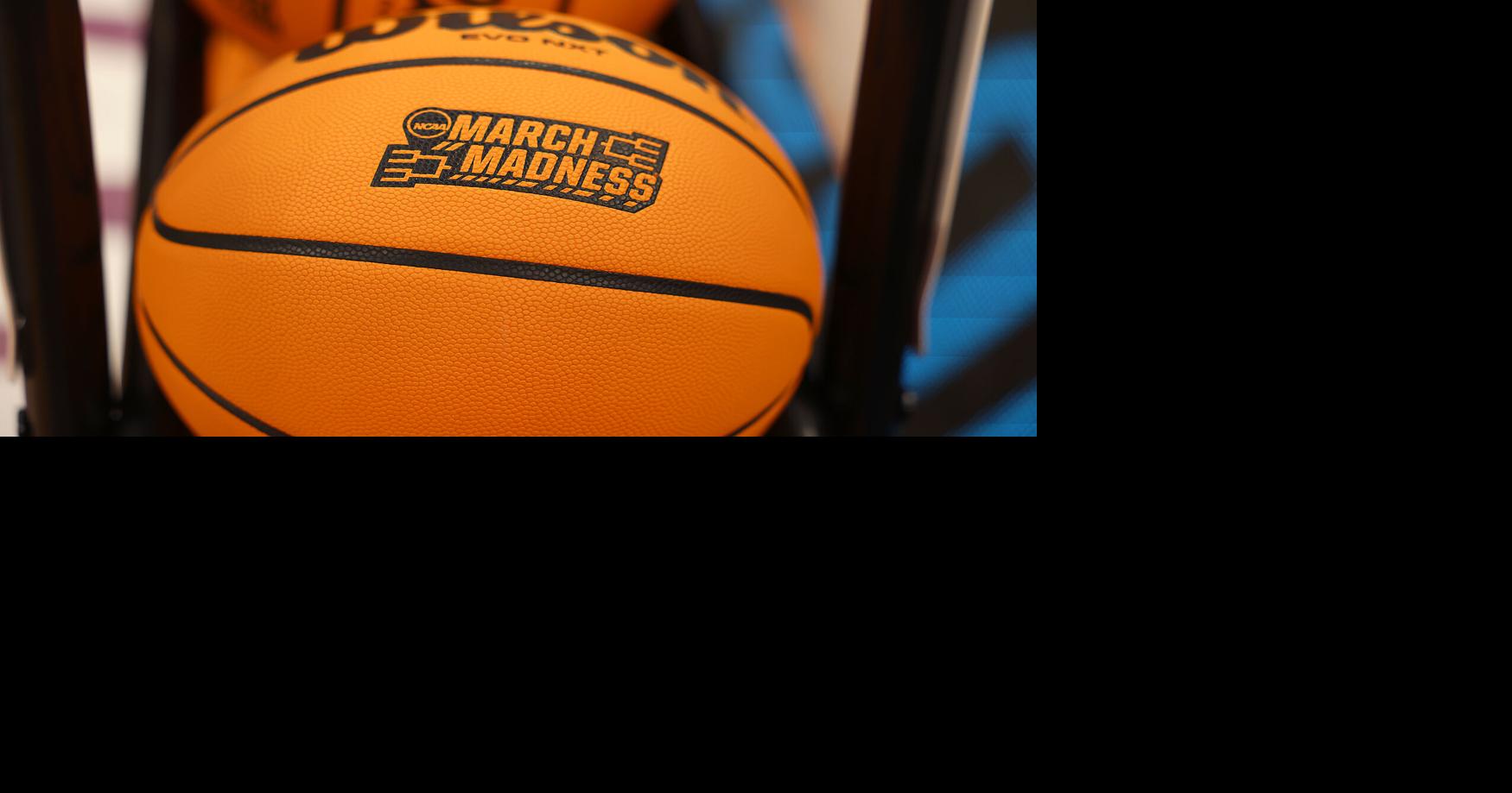 a-basketball-imprinted-with-the-ncaa-march-madness-tournament-logo-sits