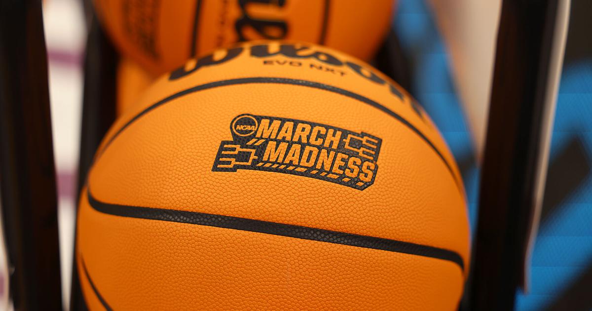 A Basketball Imprinted With The NCAA March Madness Tournament Logo Sits a-basketball-imprinted-with-the-ncaa-march-madness-tournament-logo-sits