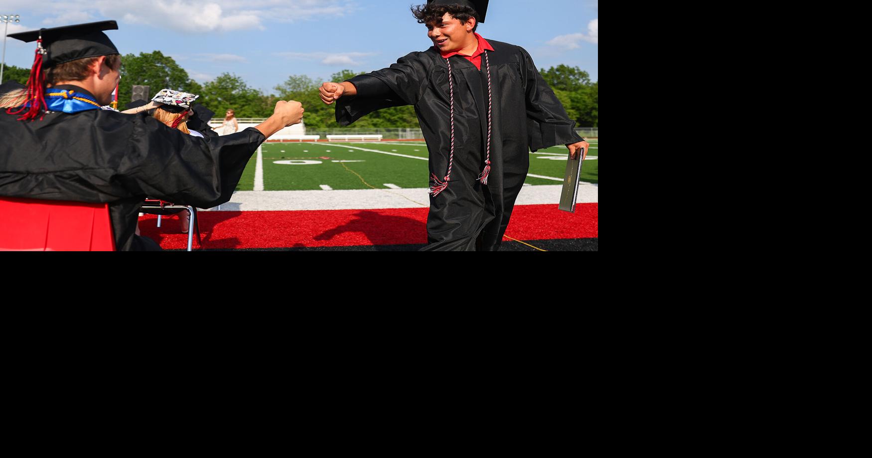 Hunter Skouby fist bumps Anthony Basinger after Basinger walked the stage