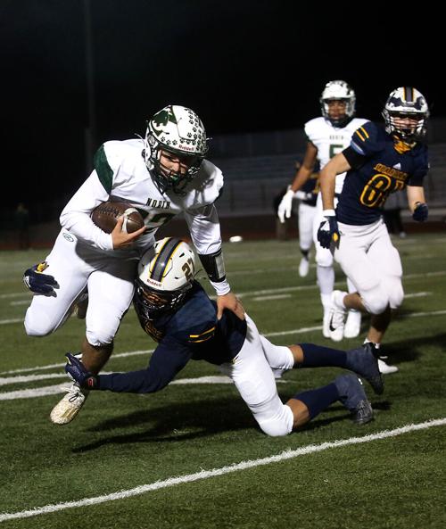 Battle junior Marquese Johnson tackles Fort Zumwalt North senior Jack Newcomb during the Class 5 state quarterfinals game