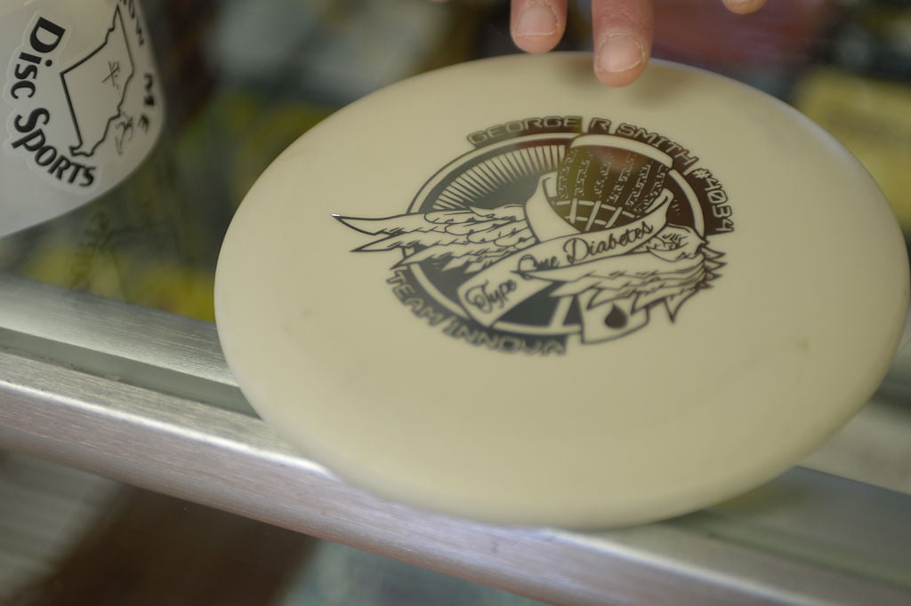George Smith shows a disc he helped create