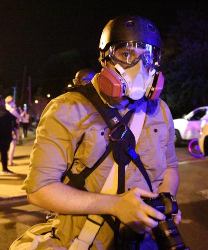 Missourian photo editor Davis Winborne watches riot police line up