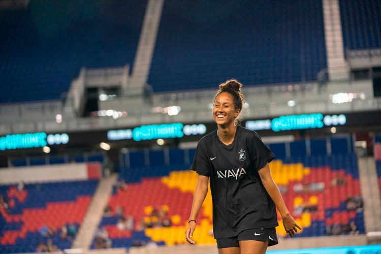 Domi Richardson smiles as she walks on to the field