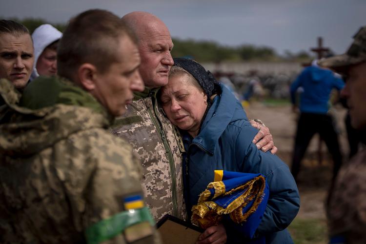 Irina Tromsa, 55, is contorted by comrades of her son Bogdan