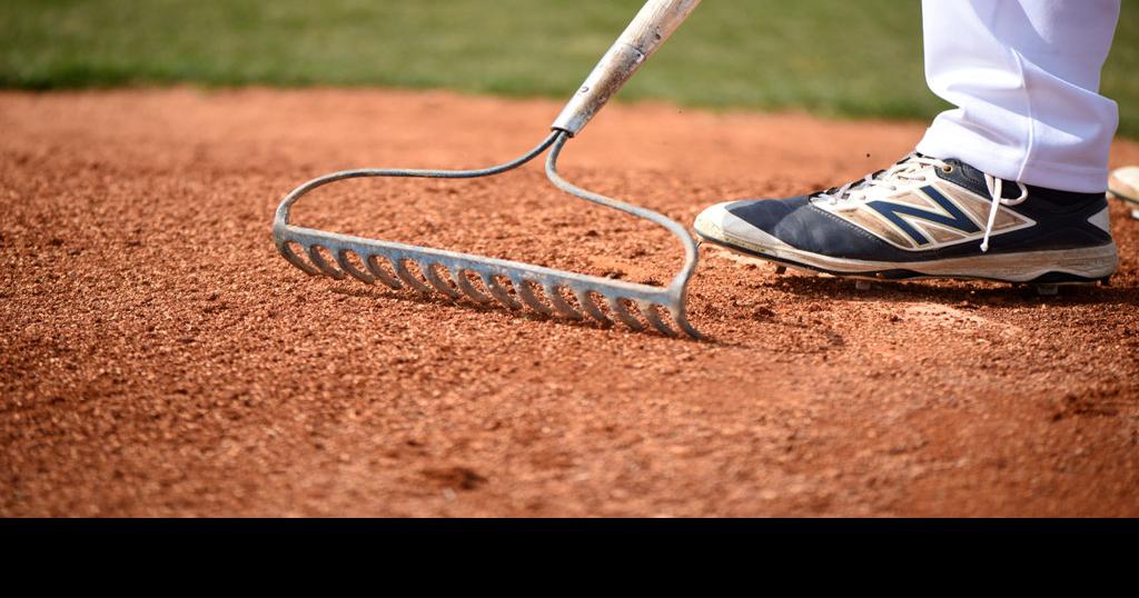 Muriel Battle High School baseball player Joe Lee rakes the pitcher's