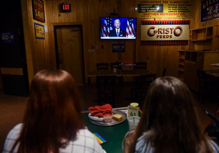 Taylor Tutin and Tori Schafer watch as Joe Biden gives his speech