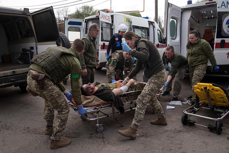 Ukrainian military medics move an injured Ukrainian serviceman to a hospital in Donetsk region