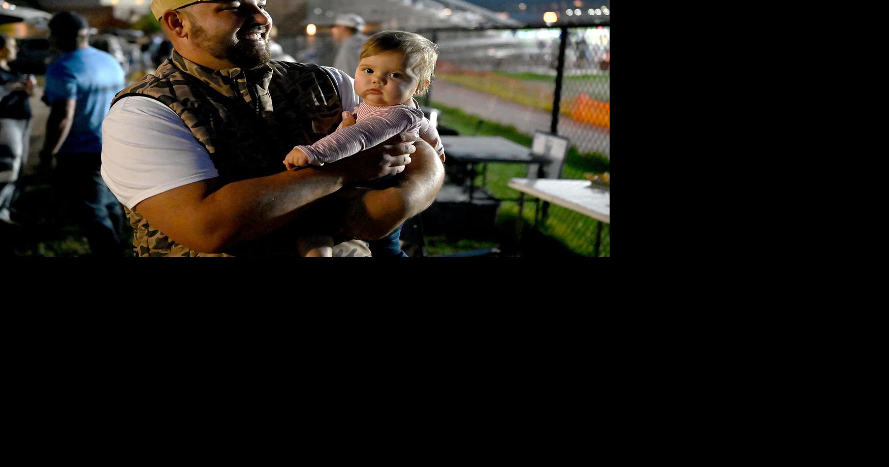 Dylan Kelly holds his daughter, 8-month-old Davie Kelly, at the family’s usual Tolton tailgate